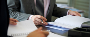 Contract being reviewed and signed at a desk